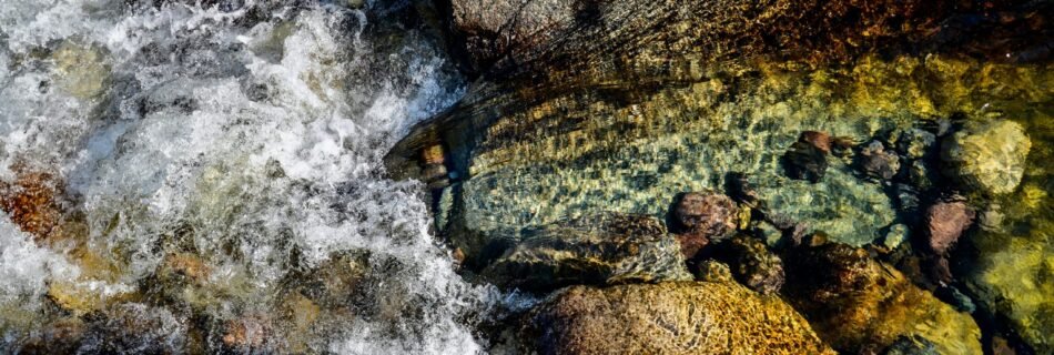 a close up of a river with rocks and water